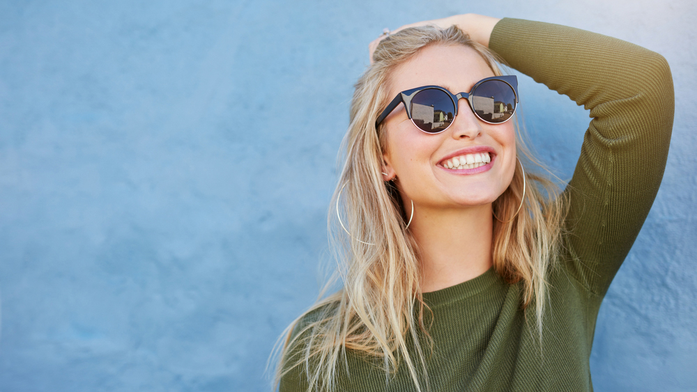 woman smiling wearing sunglasses